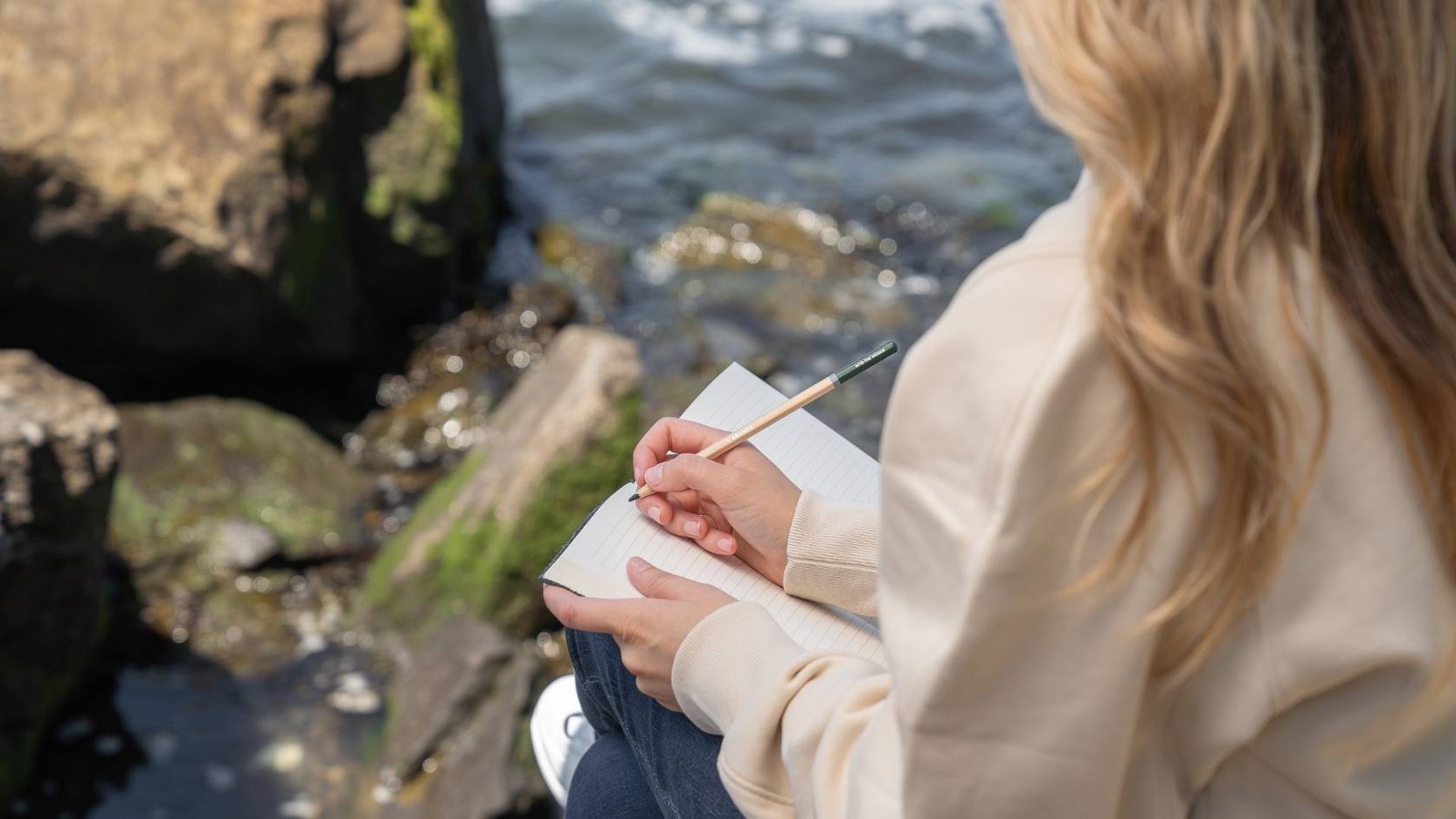 Woman writing in a diary outside