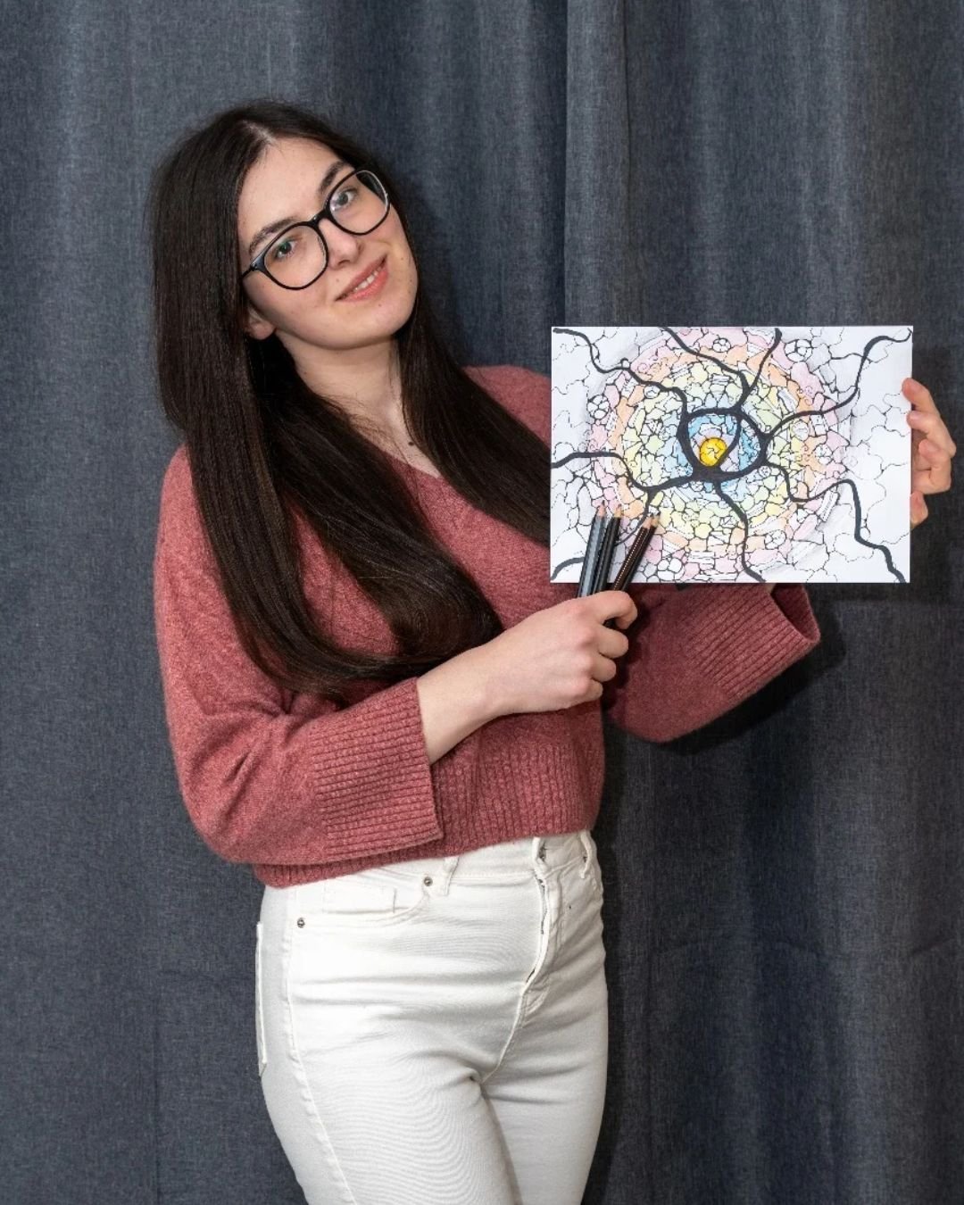 Ana Jomir holding one of her drawings