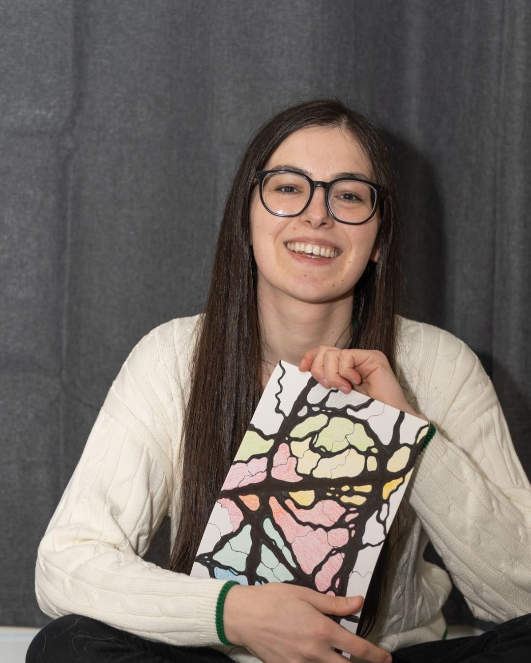Ana Jomir holding one of her drawings